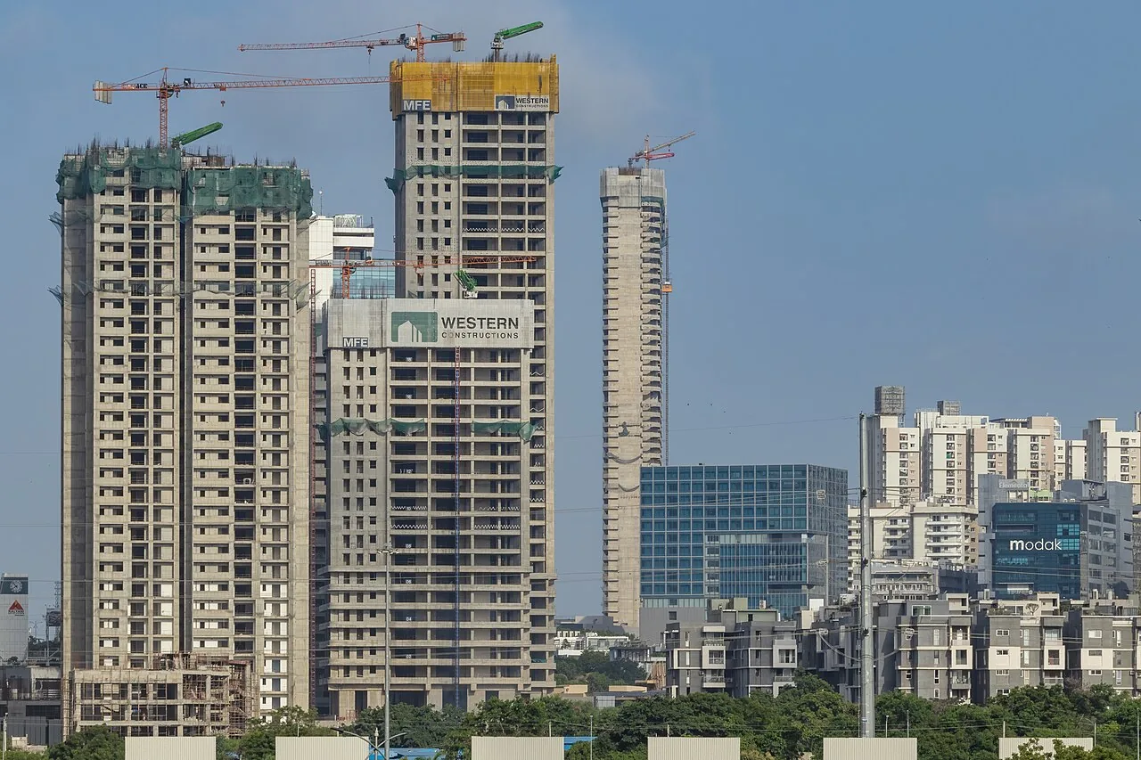 Western Springs (Hyderabad) - Active skyscraper construction with tower cranes and scaffolding - Close-up