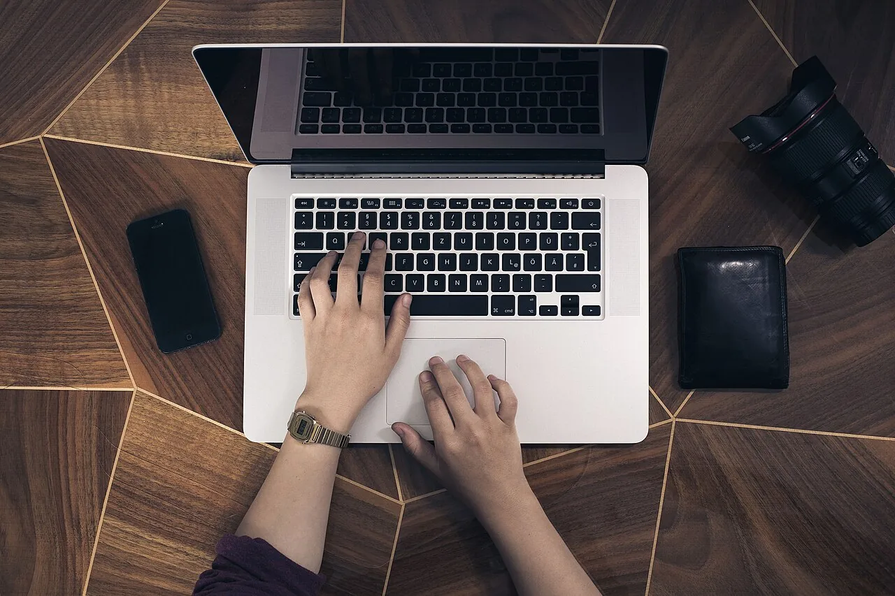 Hands on a laptop keyboard (Unsplash)